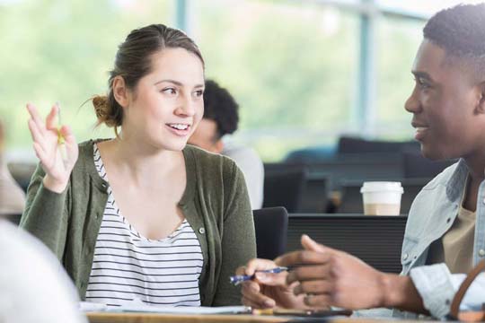 Two students enjoy lively discussion in English class