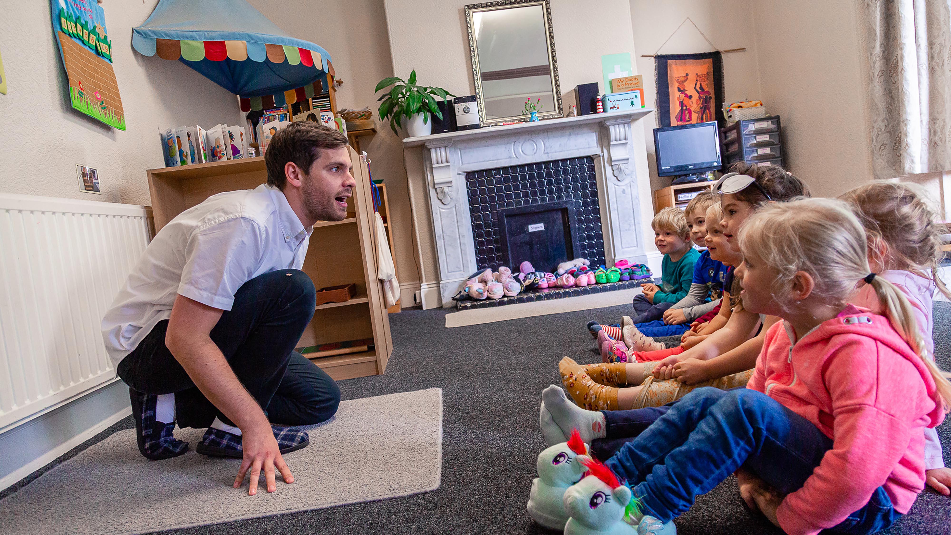 Early Years leader engages young children with a story