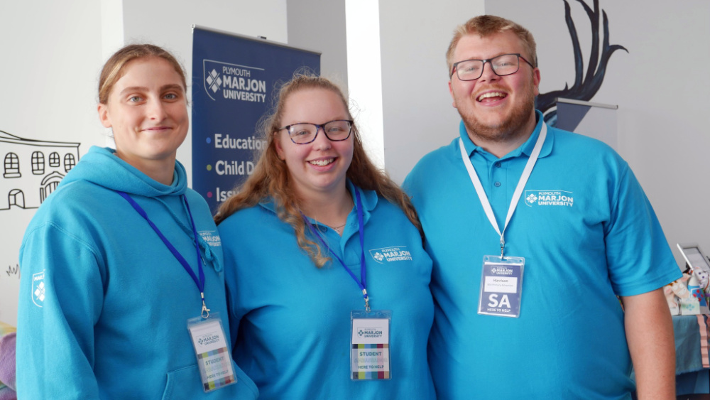 Three Marjon student ambassadors stood side by side and smiling at the camera