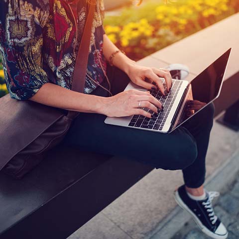 Close up of hands typing on a laptop