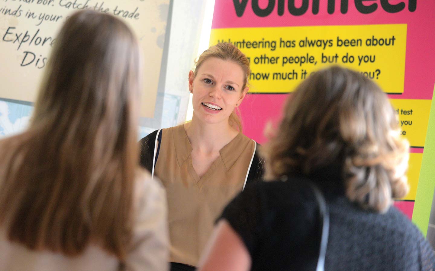 Staff member talks to visitors