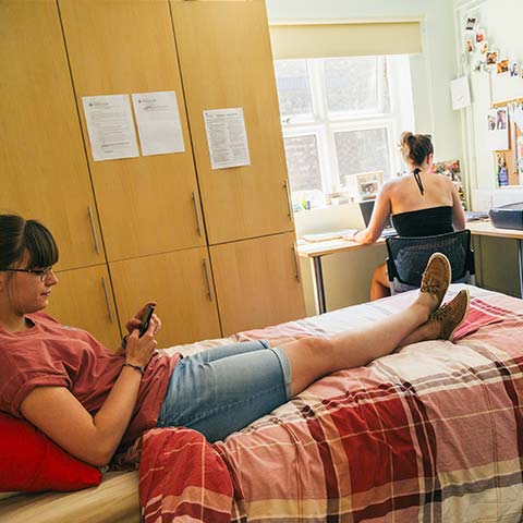Two students in a bedroom in halls