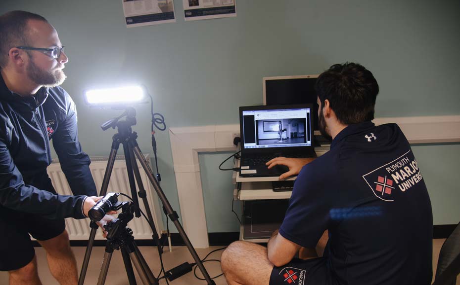 Lecturer and student set up motion cameras in the lab