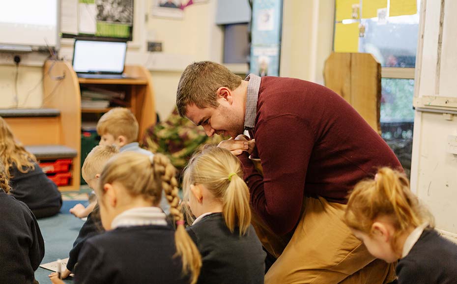 Teacher and primary school pupils at carpet time