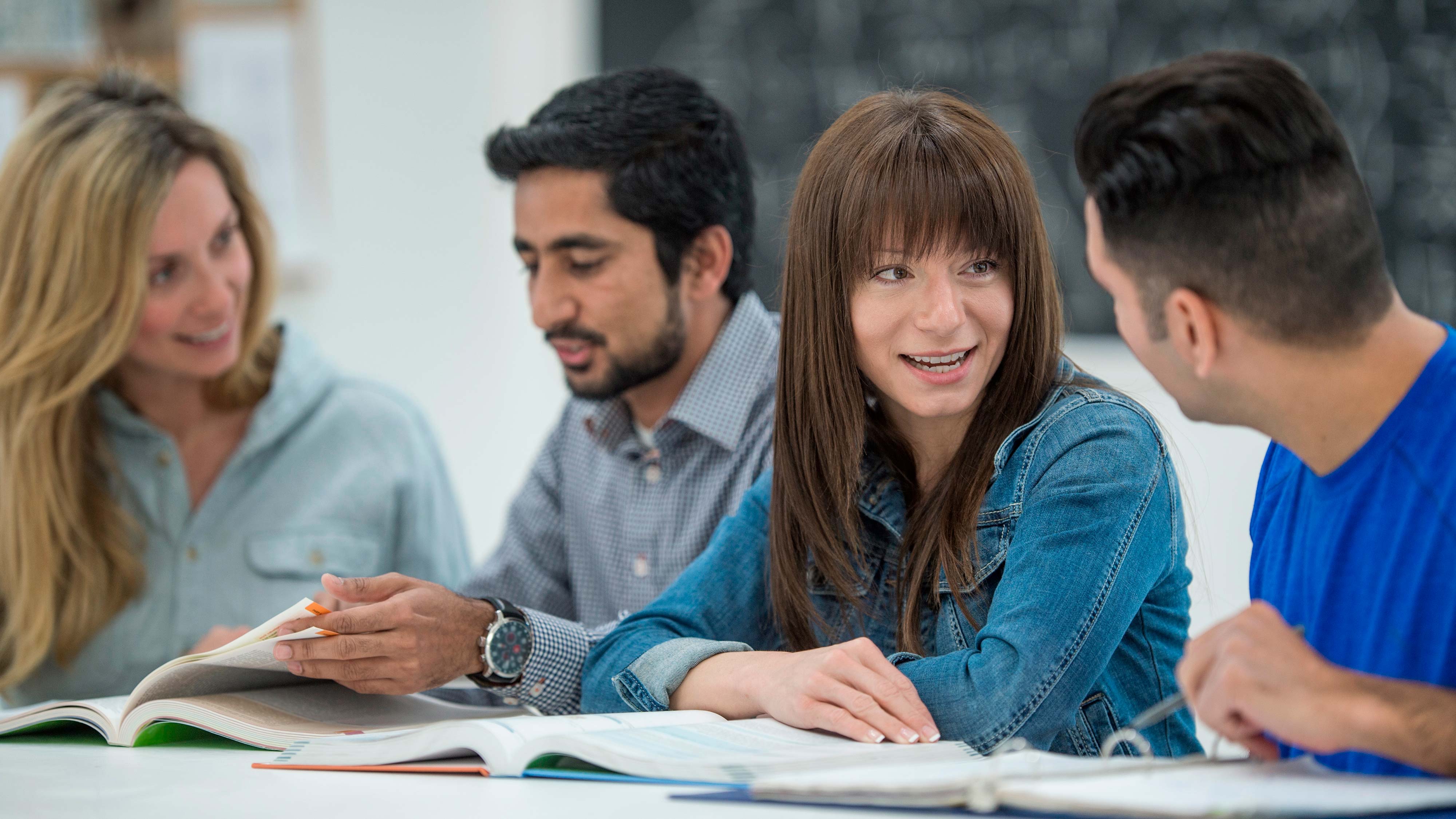 Mature students sat at a table talking