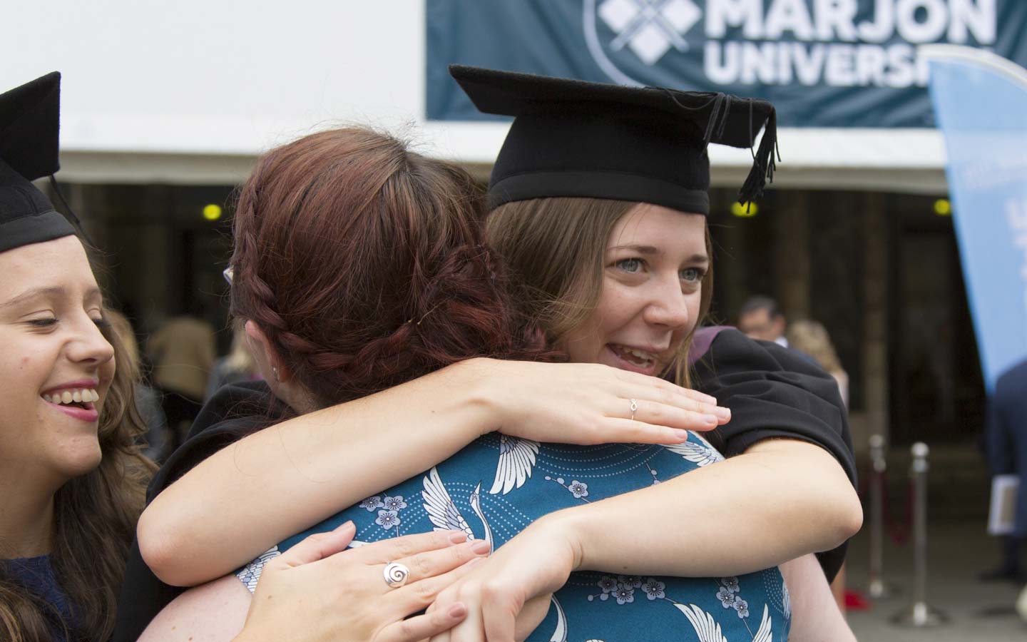 Graduate gets a hug at Marjon Graduation
