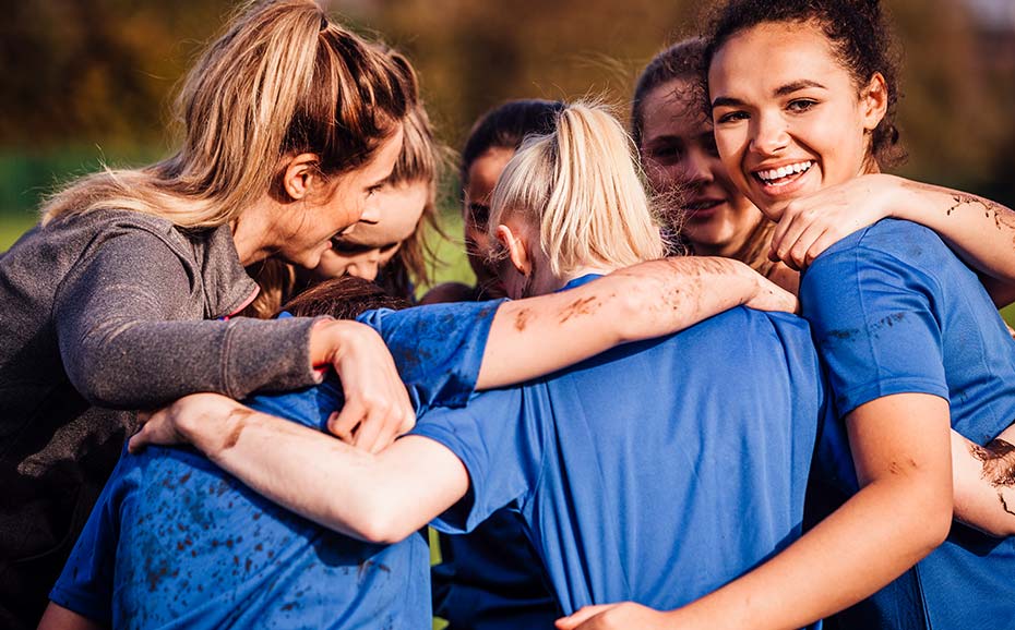 Happy and muddy school sports team