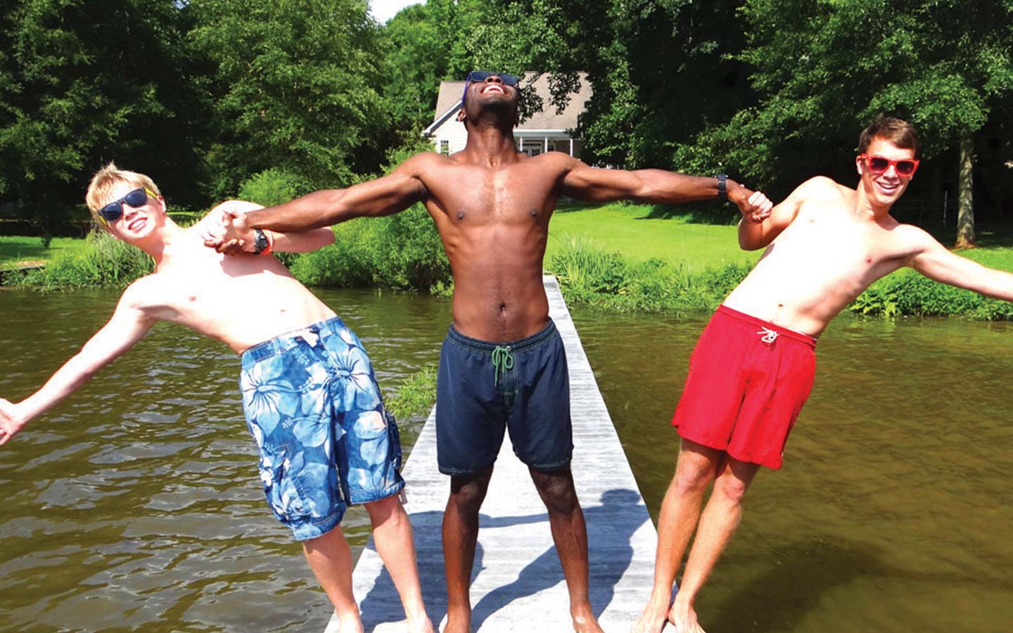 3 males stood on path over water