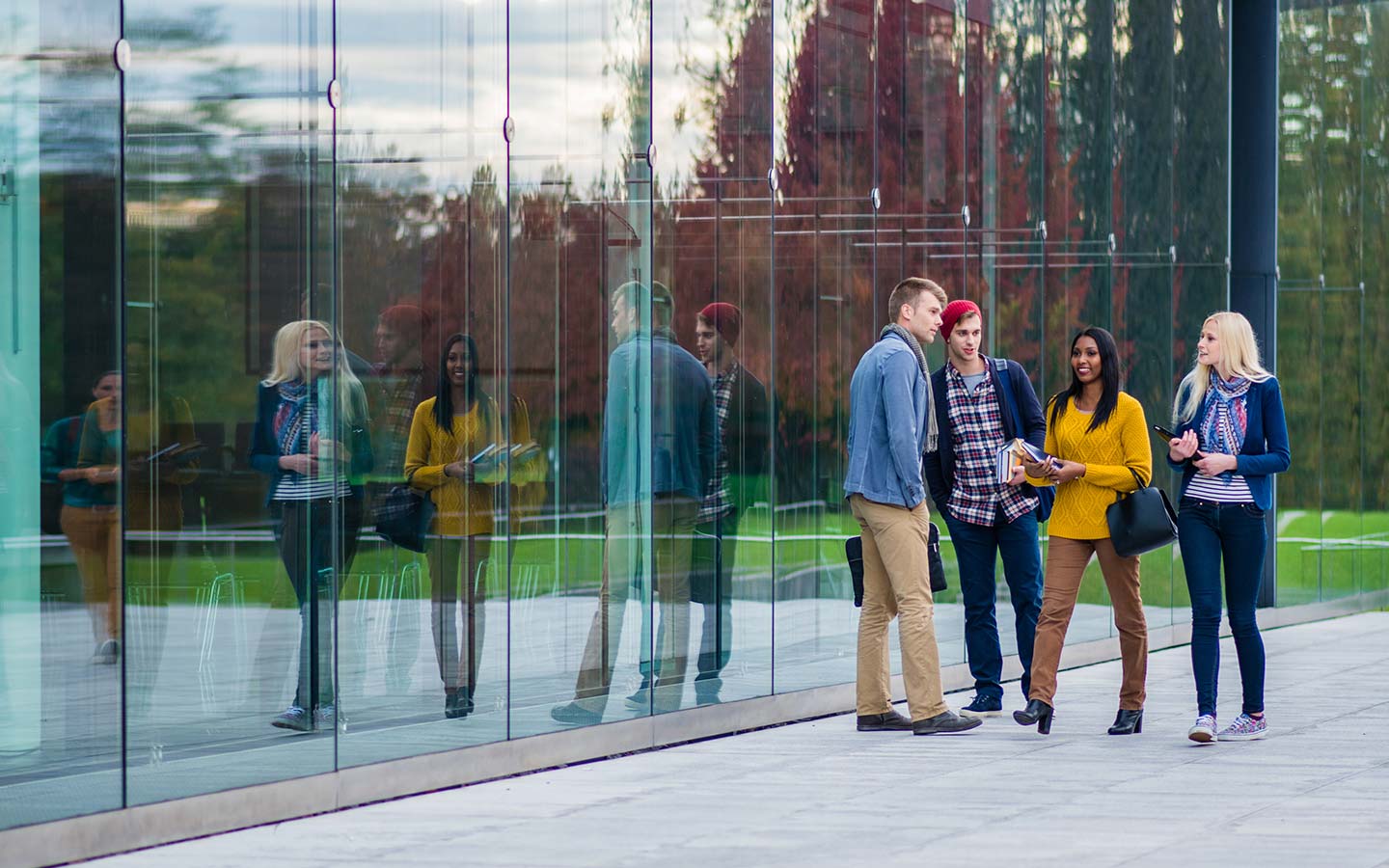 Group of students talking outside a building