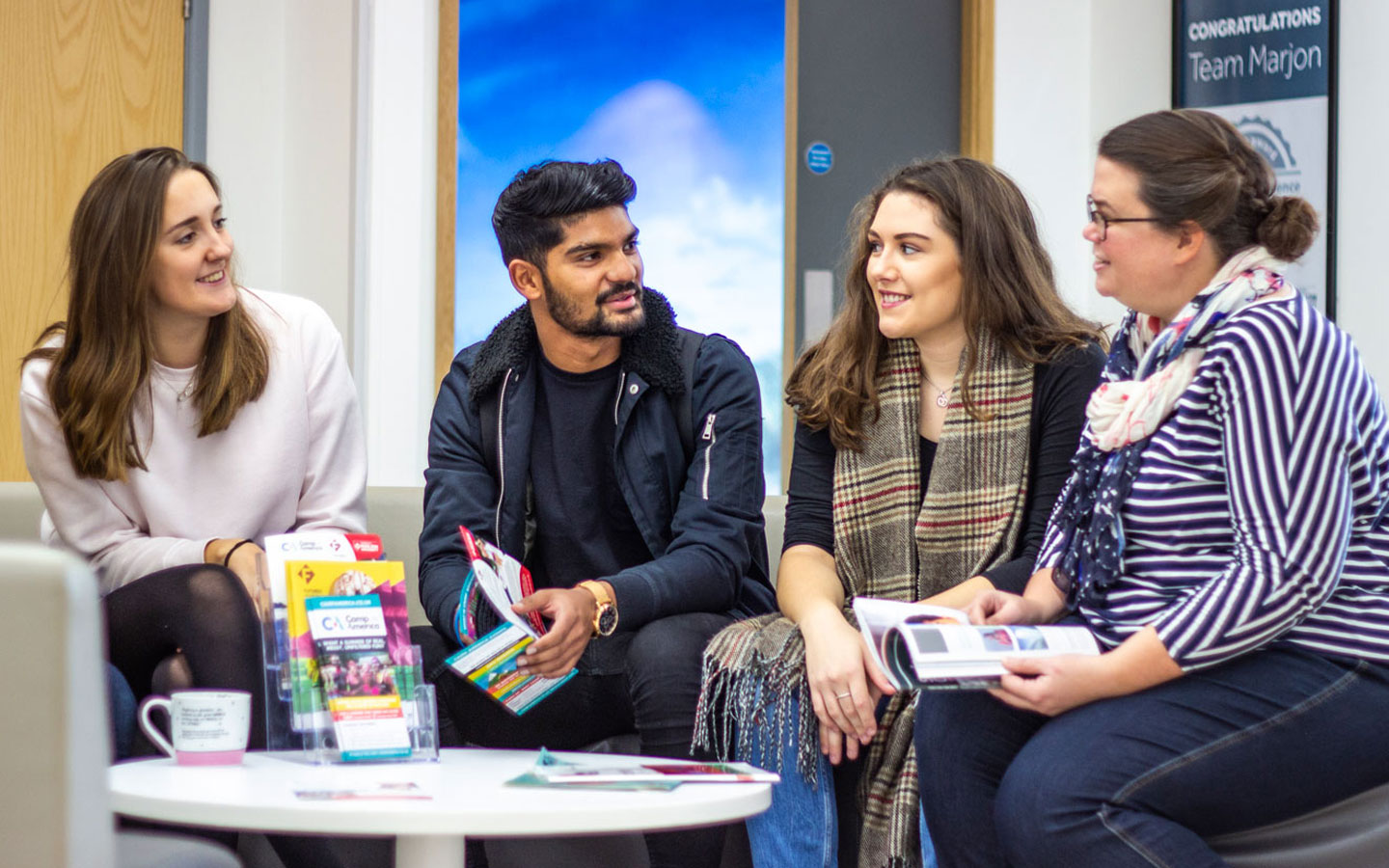 Careers Advisor working with three students