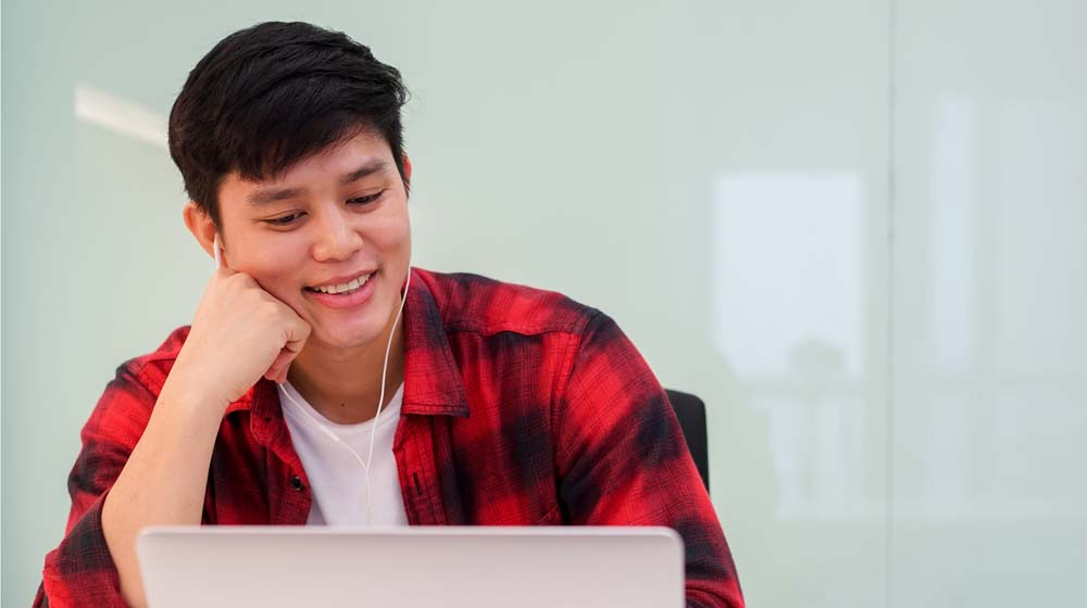 Student works at his laptop