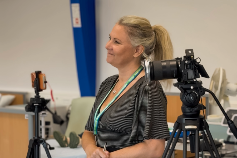 Marjon female member of staff smiling at her interview subject off screen