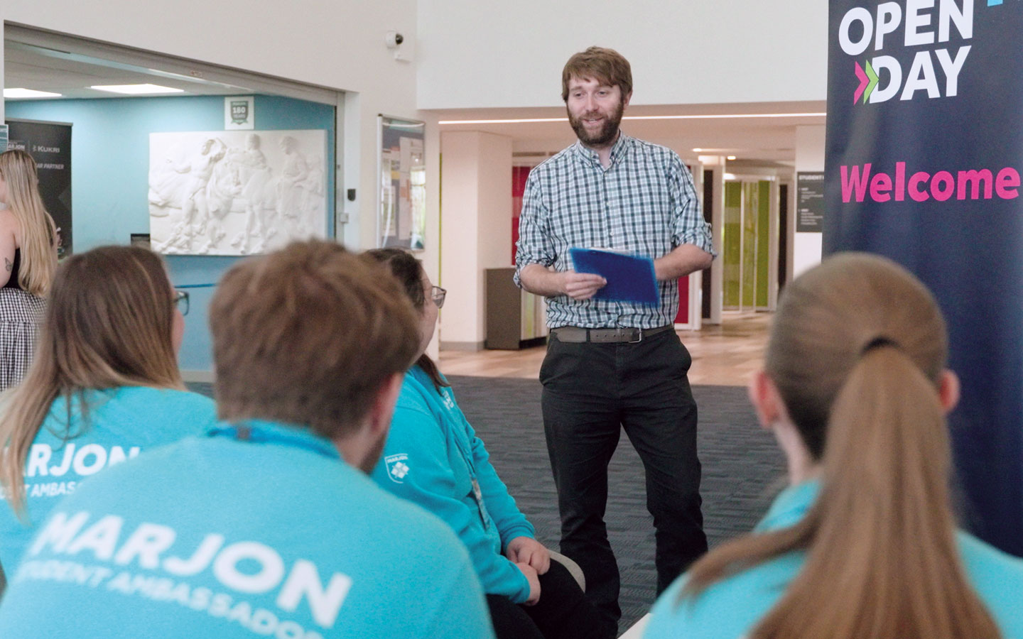 Staff member talking to Student Ambassadors
