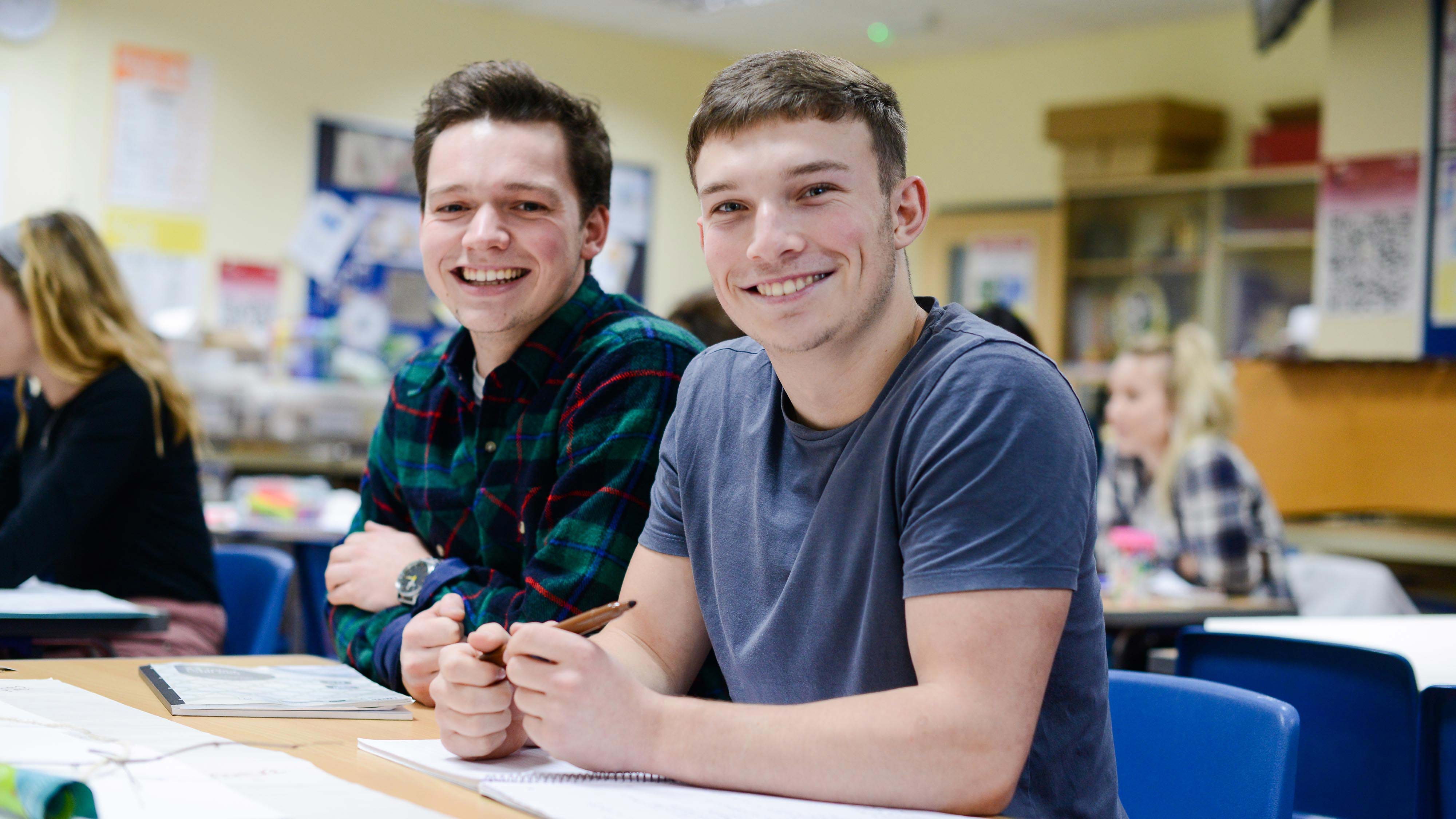 Two undergraduate students smiling directly at the camera