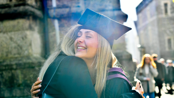 Student hugging their parent at their graduation ceremony