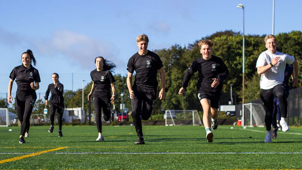 BEd PE students running across the 3G pitch