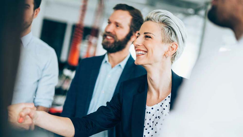 Business woman shakes hands