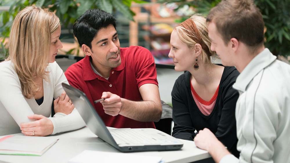 Four postgraduate students are discussing an idea