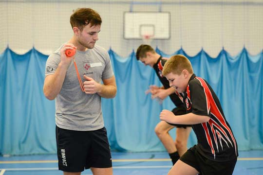 A trainee Marjon PE teacher encourages his pupil who is running