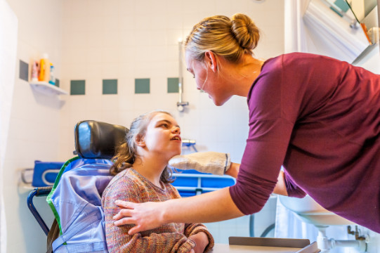 A nurse attends to a child with learning difficulties