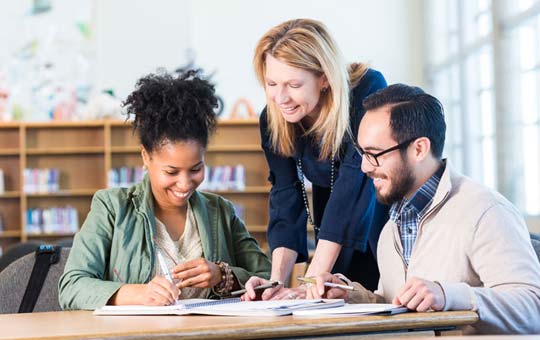 Three senior teachers planning together