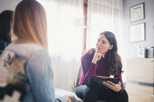 Psychologist and two clients in a couples counselling session