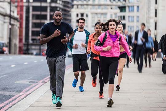 Runners on a busy city street