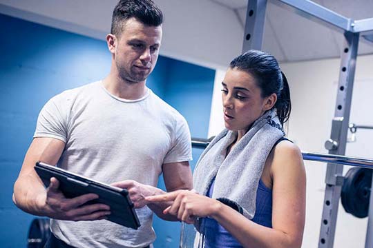 An athlete talks to a Sports Psychologist at training