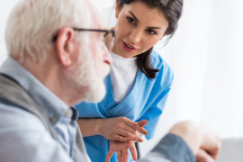 A nurse attending to an elderly patient