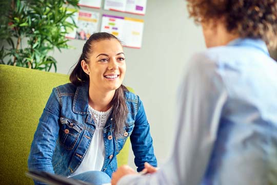 Relaxed young women speaks to a Psychologist