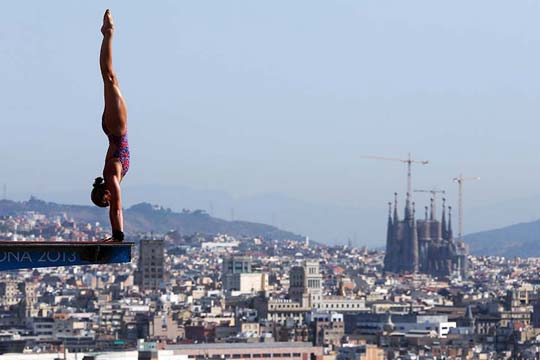 Olympic diver on the platform with a vast cityscape behind them