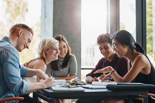 Five youth workers in discussion at a team meeting