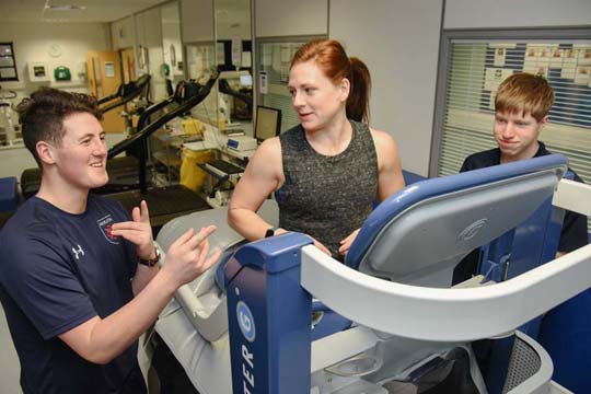Sport science students use an anti-gravity treadmill in the physiology lab