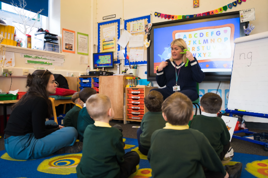 Primary school children sitting on the floor for story time
