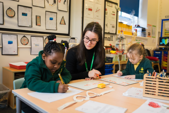 Marjon primary education student teaching two young children