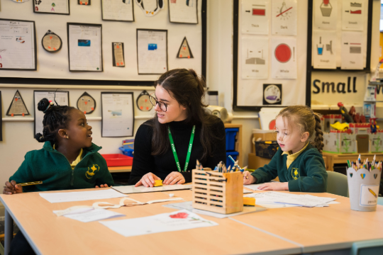 Marjon primary education student teaching two young children