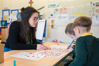 Marjon primary education student teaching two young children