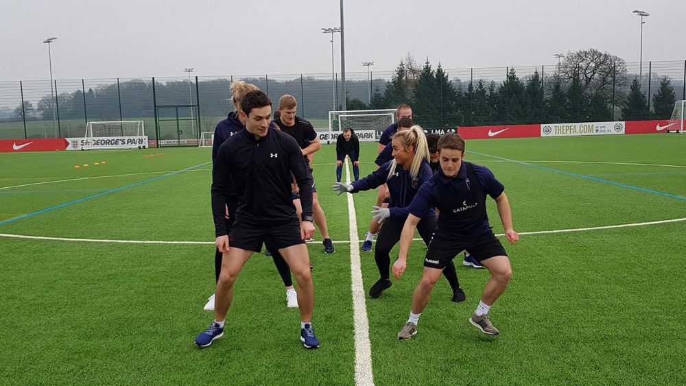 Students train on the pitch at St George's Park, the home of England football