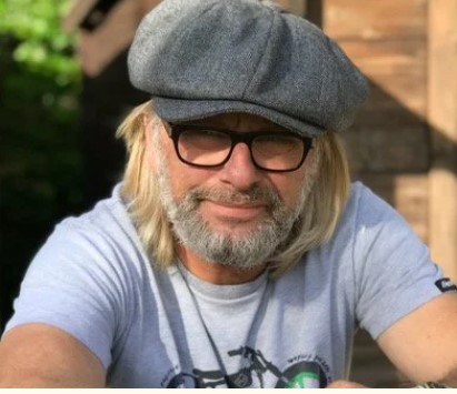 Henry Cole in flat cap smiling