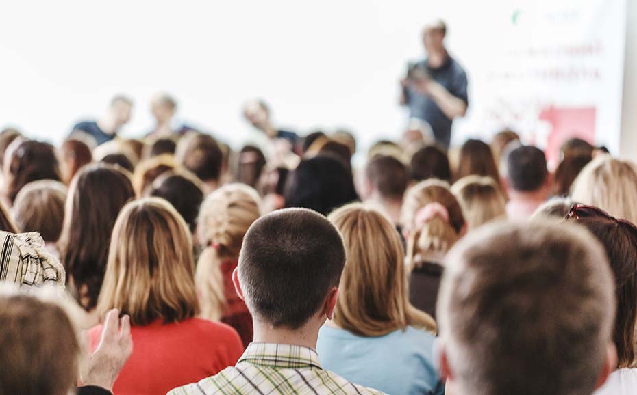 People sitting in a conference facing the stage