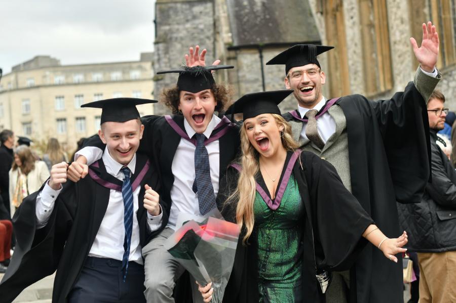 Four Marjon students looking happy after their graduation ceremony