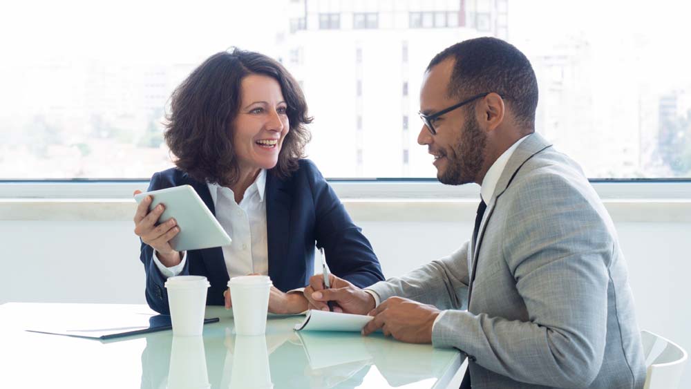 Two teachers talk at their mentoring meeting