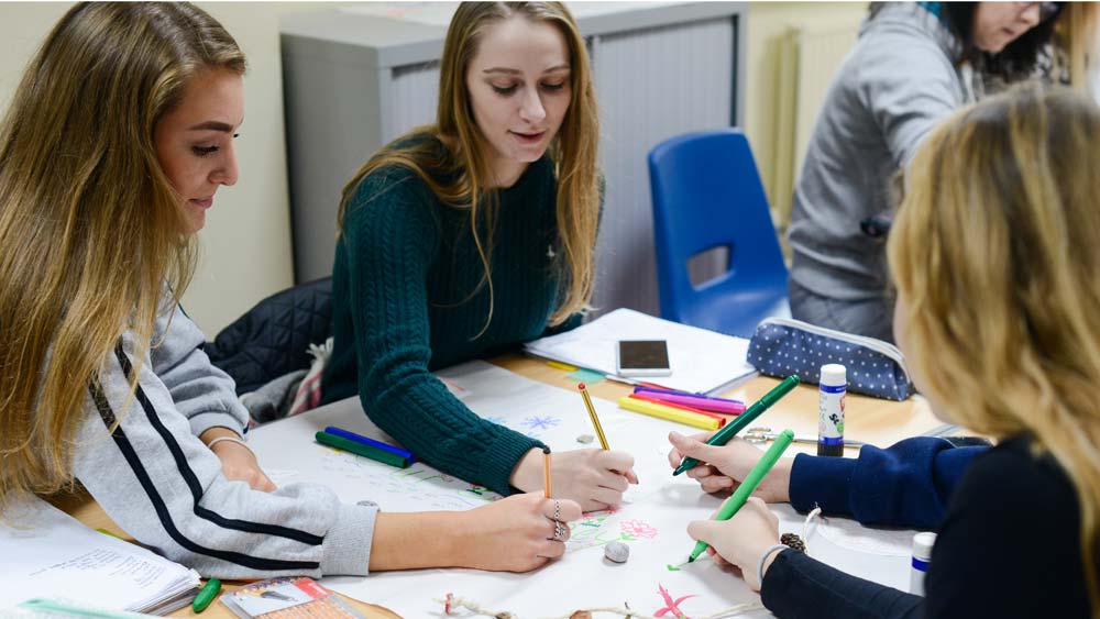 Three candidates collaborate on a group task