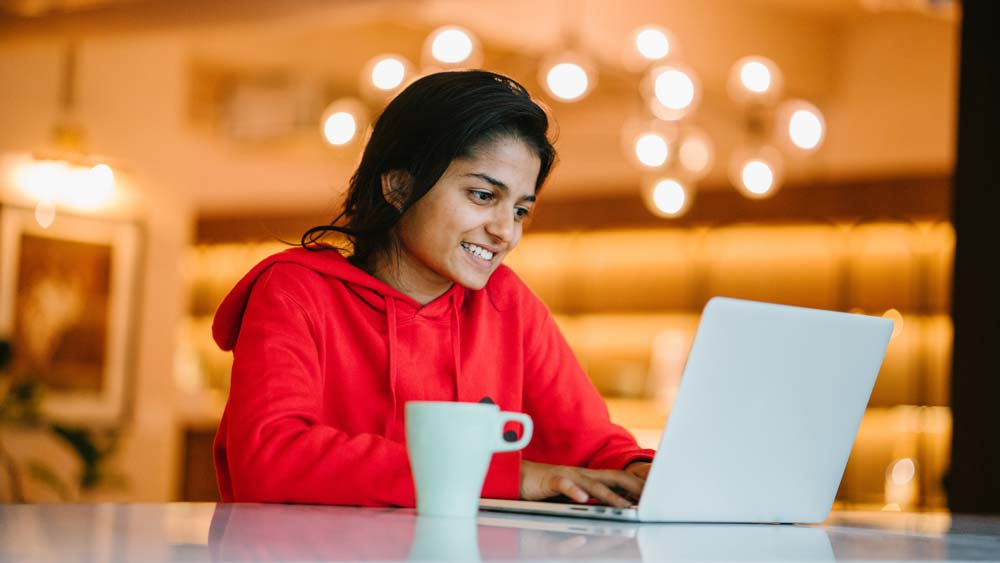 Student types her personal statement using a laptop