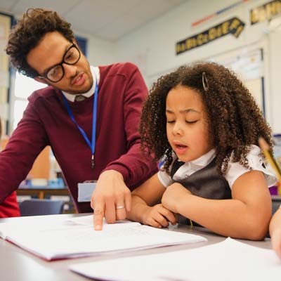 A teacher works one to one with a child