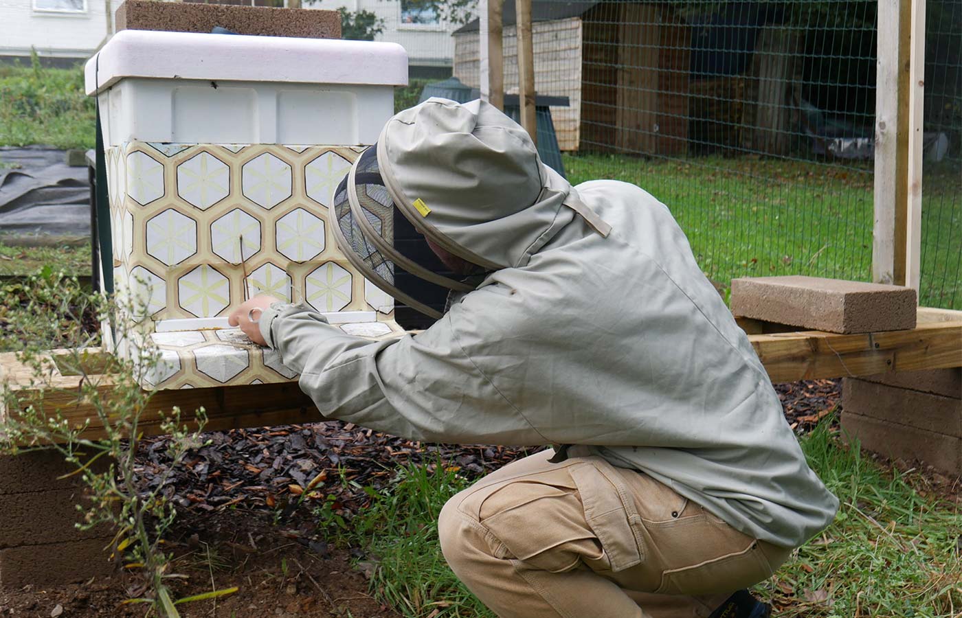 Bee keeper checking in on the bees on campus