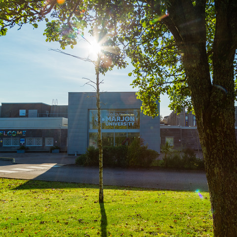 The Marjon main entrance shrouded by greenery