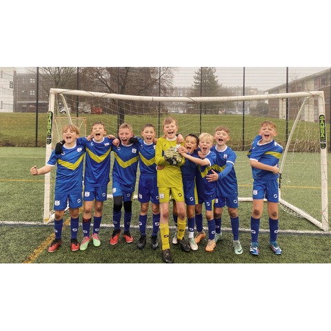 Pupils of the winning team from Elburton Primary School, grinning with their trophy.