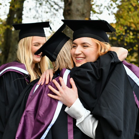 Postgraduate students celebrating at their graduation