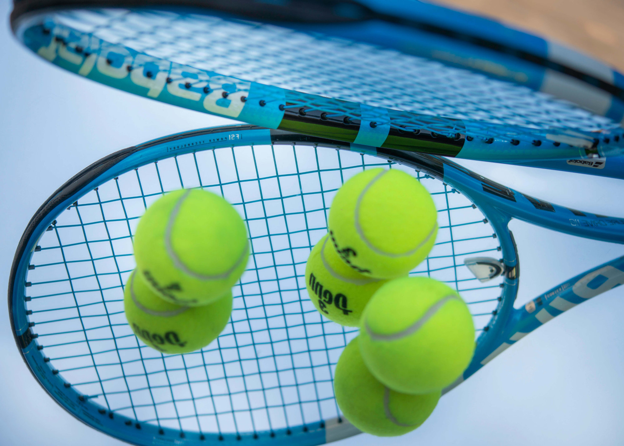 Image of some tennis rackets and tennis balls